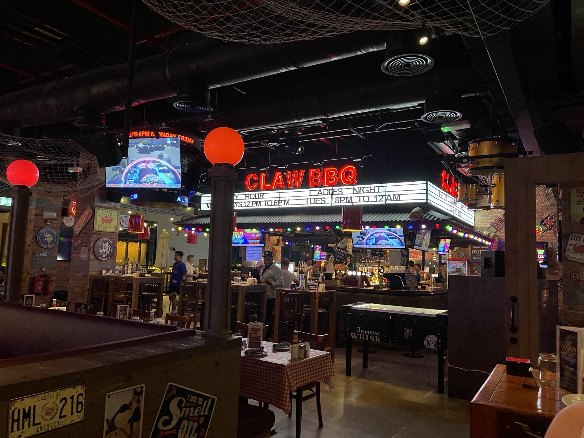 CLAW BBQ neon marquee over the bar