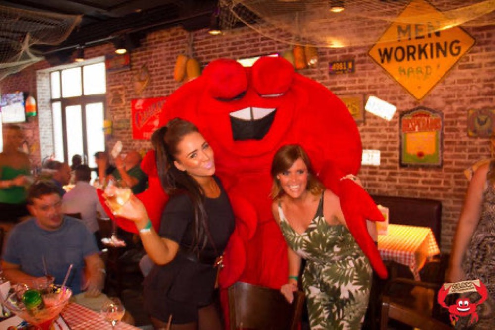 Calvin the crab mascot with guests